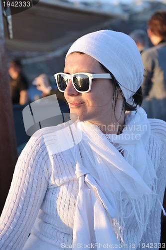 Image of Greek woman on the streets of Oia, Santorini, Greece