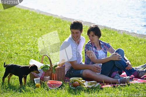 Image of happy young couple having a picnic outdoor