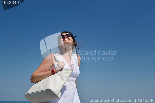 Image of young woman with spreading arms to sky