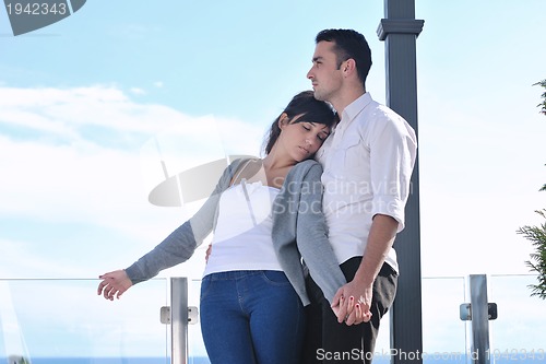 Image of couple relaxing on balcony