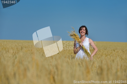 Image of young woman in wheat field at summer