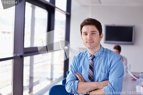 Image of business man  on a meeting in offce with colleagues in backgroun