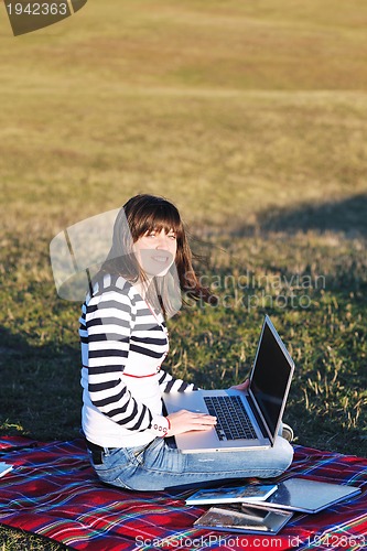 Image of young teen girl work on laptop outdoor