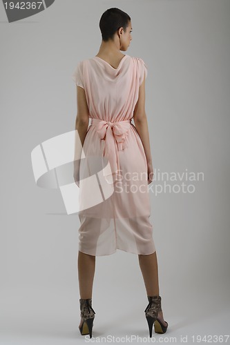 Image of elegant woman in fashionable dress posing in the studio