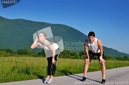 Image of Couple doing stretching exercise  after jogging