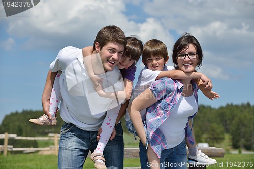 Image of happy young family have fun outdoors