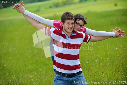 Image of Portrait of romantic young couple smiling together outdoor
