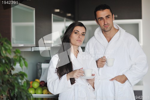 Image of Young love couple taking fresh morning cup of coffee