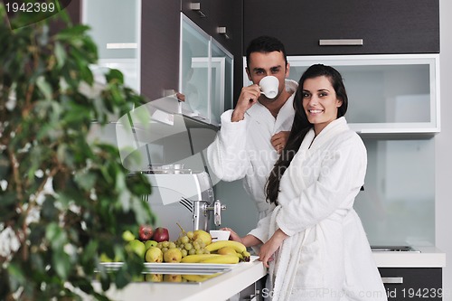 Image of Young love couple taking fresh morning cup of coffee