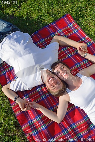 Image of happy young couple having a picnic outdoor