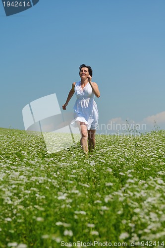 Image of Young happy woman in green field