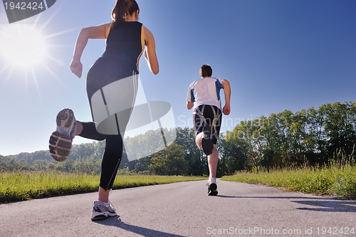 Image of Young couple jogging