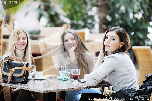 Image of cute smiling women drinking a coffee