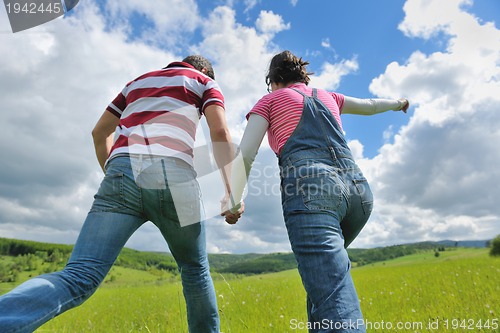 Image of Portrait of romantic young couple smiling together outdoor