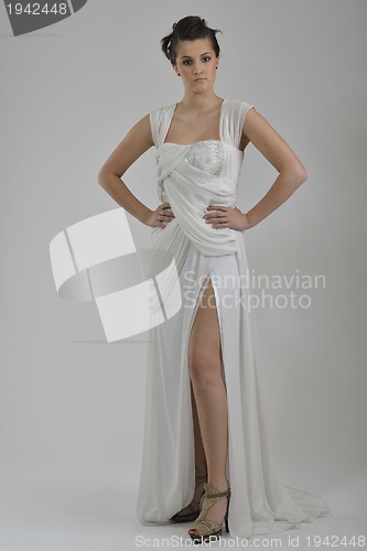 Image of elegant woman in fashionable dress posing in the studio