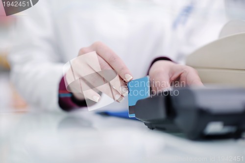 Image of pharmacist chemist woman standing in pharmacy drugstore