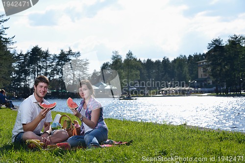 Image of happy young couple having a picnic outdoor