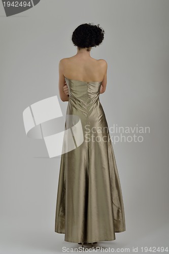 Image of elegant woman in fashionable dress posing in the studio