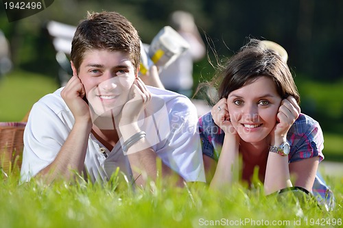 Image of happy young couple having a picnic outdoor
