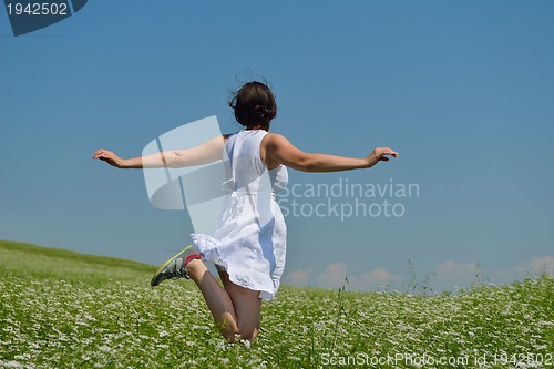 Image of Young happy woman in green field
