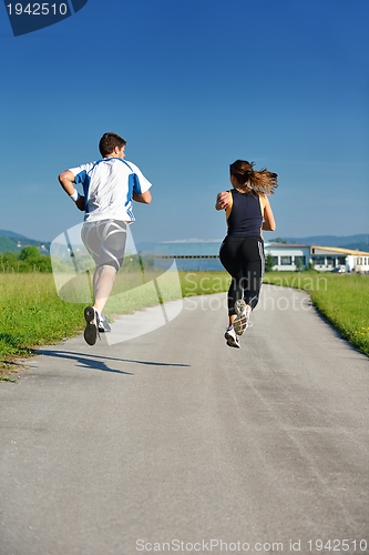 Image of Young couple jogging at morning