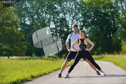 Image of Couple doing stretching exercise  after jogging