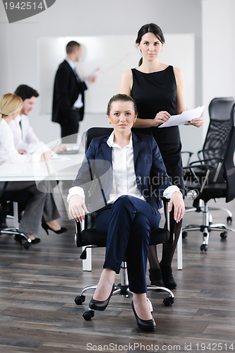 Image of business woman with her staff in background