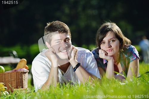 Image of happy young couple having a picnic outdoor