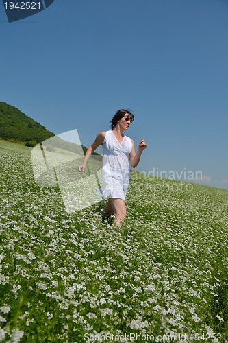 Image of Young happy woman in green field