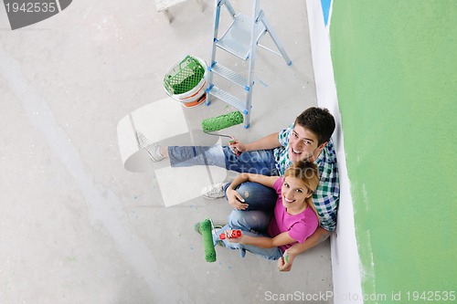 Image of happy young cople relaxing after painting in new home