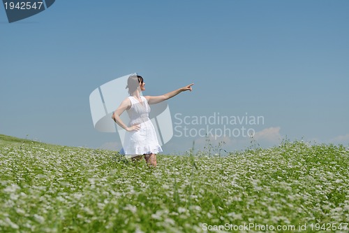 Image of Young happy woman in green field