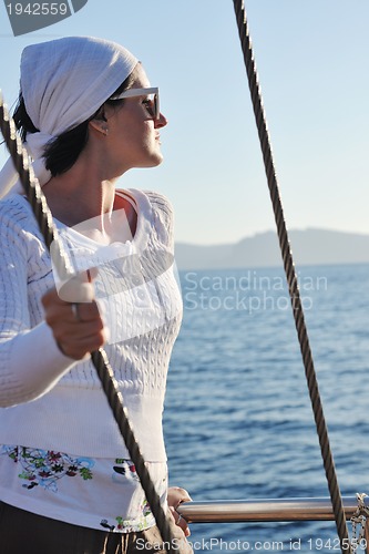 Image of Greek woman on the streets of Oia, Santorini, Greece