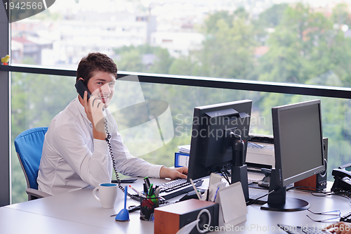 Image of happy young business man at office