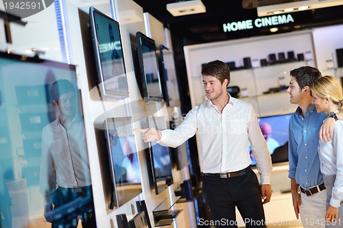 Image of Young couple in consumer electronics store