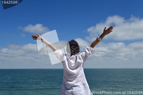 Image of happy young woman with spreading arms to sky