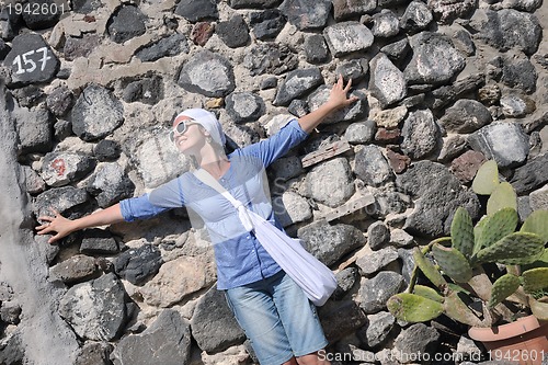 Image of Greek woman on the streets of Oia, Santorini, Greece