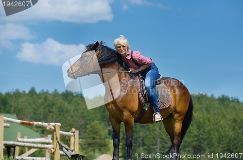 Image of happy woman  on  horse