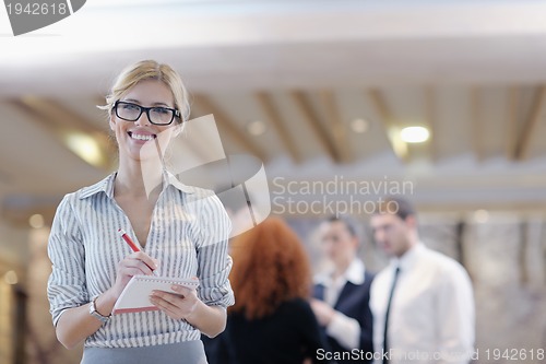Image of business woman standing with her staff at conference