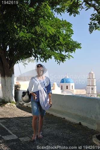 Image of Greek woman on the streets of Oia, Santorini, Greece