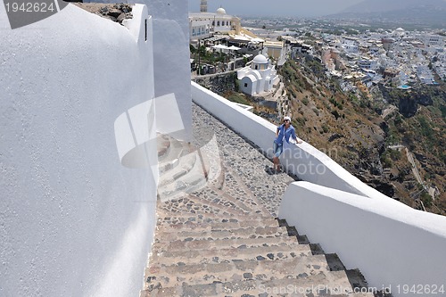 Image of Greek woman on the streets of Oia, Santorini, Greece