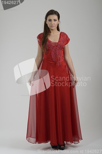Image of elegant woman in fashionable dress posing in the studio