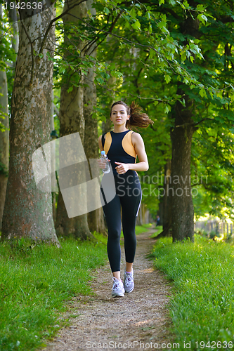 Image of Young beautiful  woman jogging