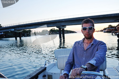 Image of portrait of happy young man on boat