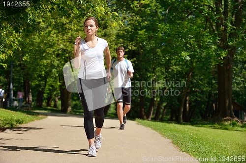 Image of Young couple jogging at morning