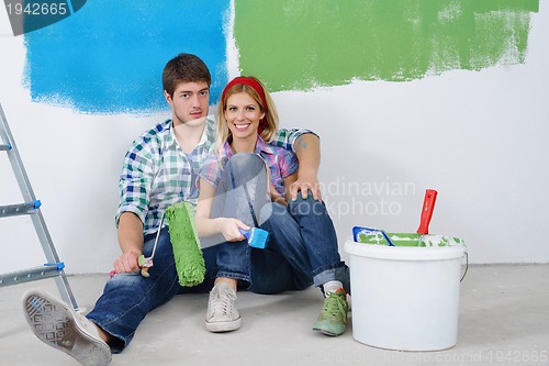 Image of happy young cople relaxing after painting in new home