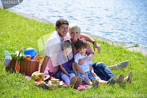 Image of Happy family playing together in a picnic outdoors