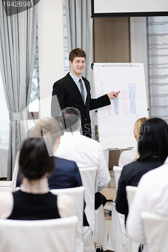 Image of Young  business man giving a presentation on conference