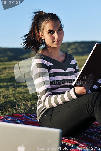 Image of young teen girl work on laptop outdoor