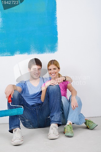 Image of happy young cople relaxing after painting in new home