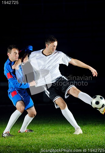 Image of football players in action for the ball